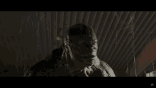 a man in a spiderman costume is crouched down in a hallway