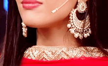 a close up of a woman 's face wearing a microphone and earrings .