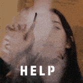 a woman is smoking a cigarette and the word help is on the bottom