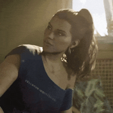 a woman wearing a blue shirt that says cellhorn