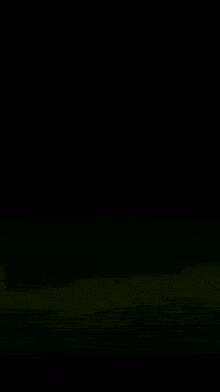 a blurry picture of a yellow light coming out of a black background