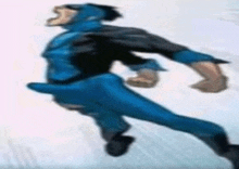 a man in a blue and black superhero costume is flying through the air