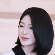 a close up of a woman with short black hair