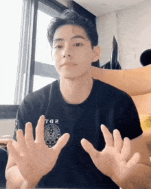 a man wearing a black t-shirt that says tq2 on it