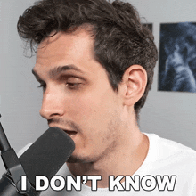 a man singing into a microphone with the words " i don 't know " on the bottom