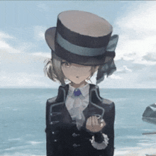 a girl in a top hat stands in front of a body of water
