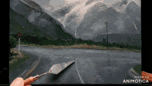 a painting of a road with mountains in the background is made by animatica