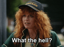 a woman with red hair wears a hat that says stetson