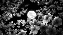 a black and white photo of a full moon and flowers