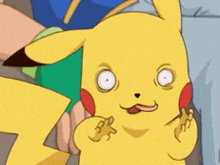 a close up of a pikachu making a funny face with his tongue out .
