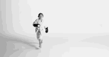 a black and white photo of a little girl wearing roller skates and a robe .