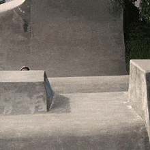 a person riding a skateboard down a ramp in a skate park