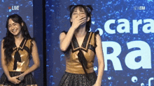 a woman laughs in front of a screen that says live
