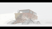 a tractor is driving through the snow in a foggy day