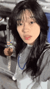 a woman taking a selfie with a sword in her hand and a shirt that says nike on it
