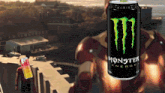 a can of monster energy sits in front of a man