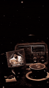 a lg radio sits on a table next to a cup and saucer