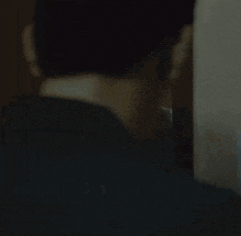 a man is looking at himself in the mirror .