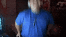 a blurry image of a man wearing headphones and a blue shirt .