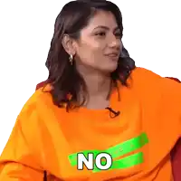 a woman wearing an orange shirt with the word no written on it