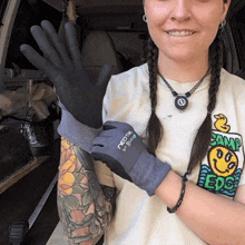 a woman wearing a shirt with a smiley face and the word camp on it