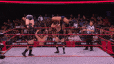 wrestlers in a ring with a banner that says ring of honor on it