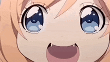 a close up of a girl 's face with her mouth open and fangs .
