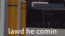 a sign that says lawd he comin in front of some yellow poles