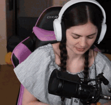 a woman wearing headphones and a dxr chair