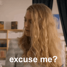 a woman with blonde hair says excuse me ?