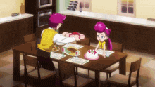 a man is giving a gift to a girl at a table with a cake on it