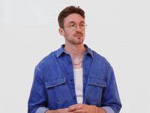 a man with glasses and a chain around his neck