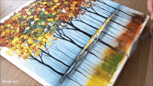 a painting of trees with autumn leaves on a canvas with wow art written on the bottom