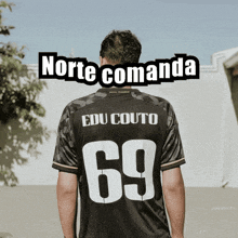 a man is wearing a black jersey with the number 69 on it