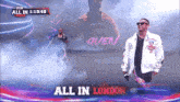 a man in a white jacket is walking on a stage with the words all in london behind him