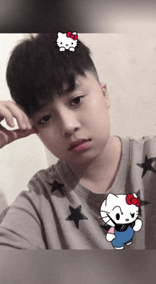 a young boy with a hello kitty sticker on his forehead