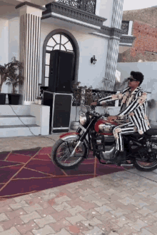 a man in a black and white suit is riding a motorcycle