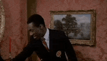 a man in a suit and tie holding a sign that says your gif