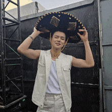 a man wearing a sombrero and a white shirt