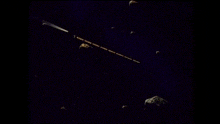 a group of asteroids are flying through a dark blue sky .
