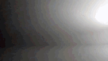 a dark room with a light coming from the corner