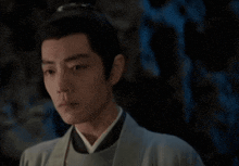 a close up of a man 's face wearing a kimono