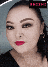 a close up of a woman 's face with a shizhi logo in the corner