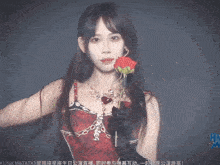 a woman in a red dress holds a rose in her hand
