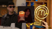 a man wearing sunglasses is holding a trophy that says master chef
