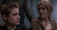 a man and a woman are sitting next to each other and looking at something