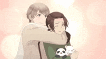 a couple of anime characters hugging each other . one of the characters is holding a panda bear .