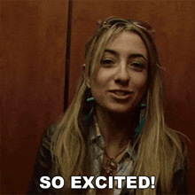 a woman in an elevator says so excited in black letters