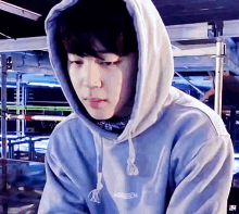 a close up of a person wearing a hoodie with a bandana around their neck .