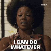 a woman with an afro says " i can do whatever " in front of a window